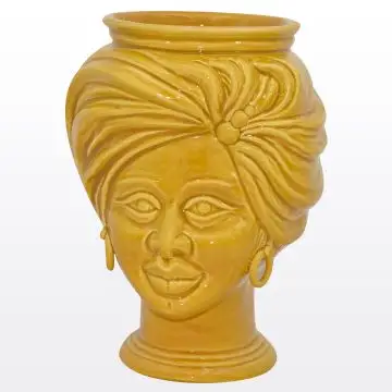 Yellow Sicilian Moorish head featuring a female character. It is handcrafted in Caltagirone, Italy.
