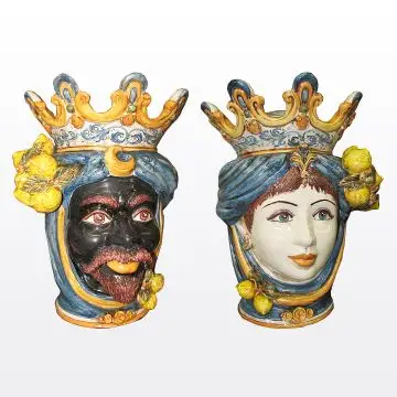 Pair of Sicilian Moorish heads with lemons. They feature a man and a woman decorated in rich shades of blue and orange. Handcrafted in Caltagirone, Italy.