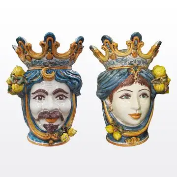 Pair of Sicilian Moorish heads with lemons. They feature a female and a male character decorated in rich shades of blue and orange. Handcrafted in Caltagirone, Italy.