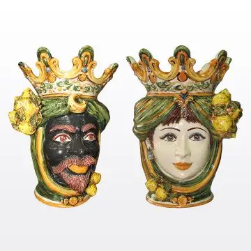 Pair of Sicilian Moorish heads with lemons. They feature a man and a woman decorated in rich shades of green and orange. Handcrafted in Caltagirone, Italy.