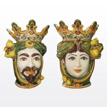 Pair of Sicilian Moorish heads with lemons. They feature a female and a male character decorated in rich shades of green and orange. Handcrafted in Caltagirone, Italy.