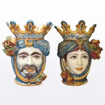 Pair of Sicilian Moorish heads with pomegranates. They feature a female and a male character decorated in rich shades of blue and orange. Handcrafted in Caltagirone, Italy.