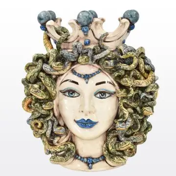 Sicilian ceramic head featuring Medusa, with snakes for hair and the ability to turn anyone who looks directly at her to stone. It is decorated with antique, mother-of-pearl glazes, which add depth and shine to its fine features.