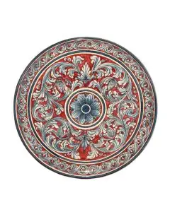 Sicilian wall plate hand-painted with an elaborate pattern on a dark pink background. The wall plate is handcrafted in Caltagirone, Italy.