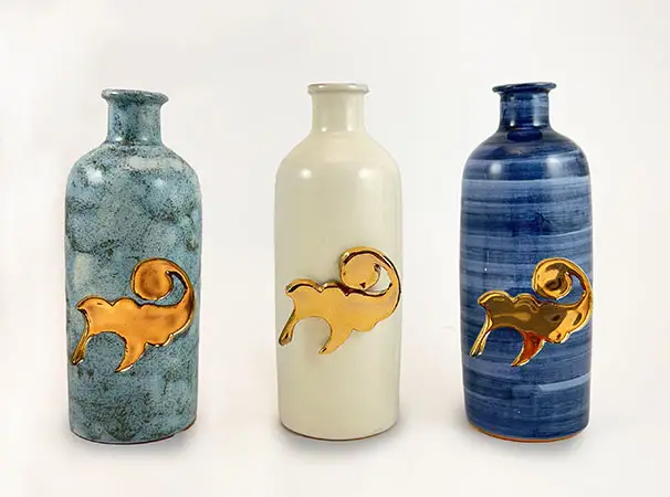 A tris of handmade ceramic bottles with gold details by Rampini, Gubbio. 